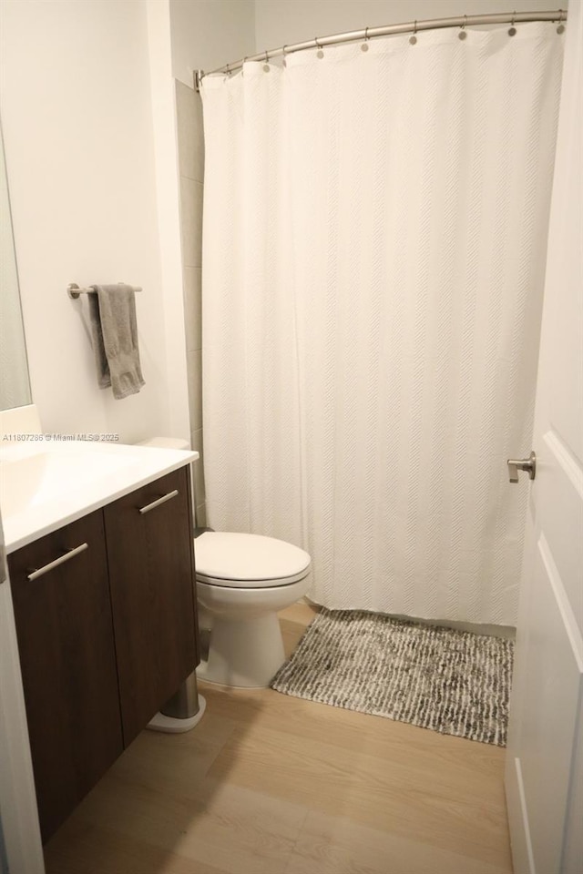 8201 NW 41st St Unit D-402, Doral, FL 33166 - bathroom featuring vanity, toilet, wood finished floors, and a shower with curtain