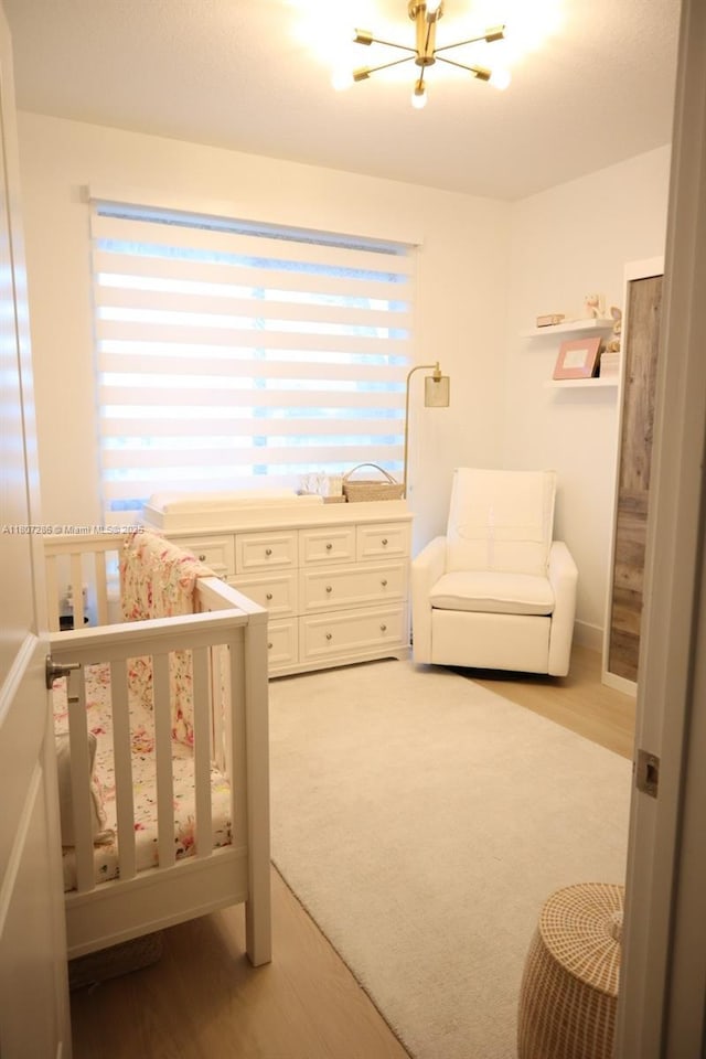 8201 NW 41st St Unit D-402, Doral, FL 33166 - bedroom with a chandelier, light wood-type flooring, and a nursery area