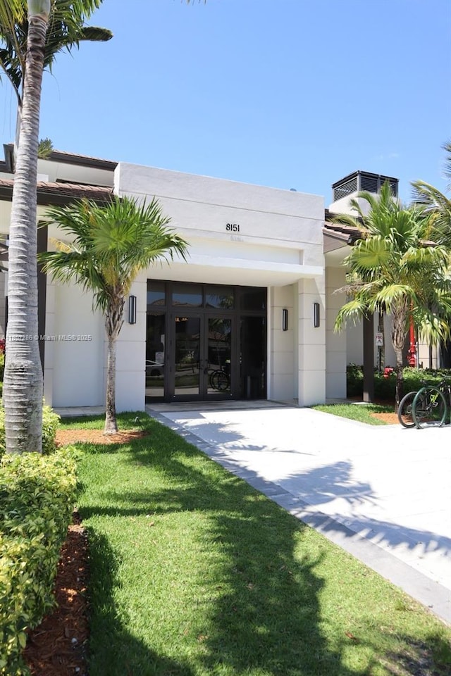 8201 NW 41st St Unit D-402, Doral, FL 33166 - view of front of house with french doors, stucco siding, and a front yard