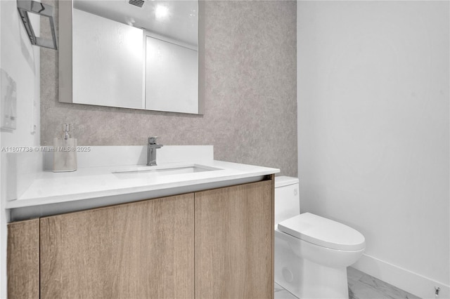 17550 Collins Ave Unit 603, Sunny Isles Beach, FL 33160 - bathroom featuring toilet, marble look tile flooring, vanity, and baseboards