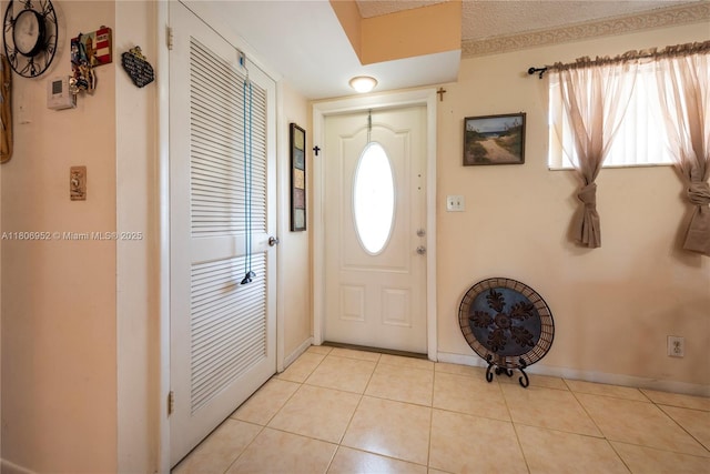 9823 S Hollybrook Lake Dr Unit 105, Pembroke Pines, FL 33025 - foyer with plenty of natural light, light tile patterned flooring, and baseboards