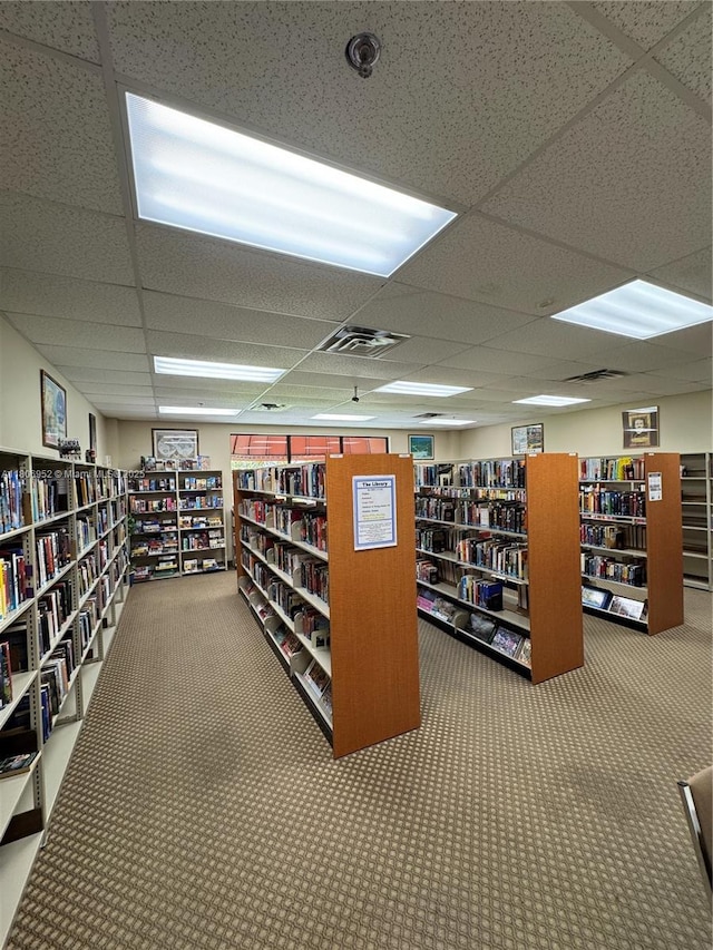 9823 S Hollybrook Lake Dr Unit 105, Pembroke Pines, FL 33025 - misc room featuring wall of books, carpet, and a paneled ceiling