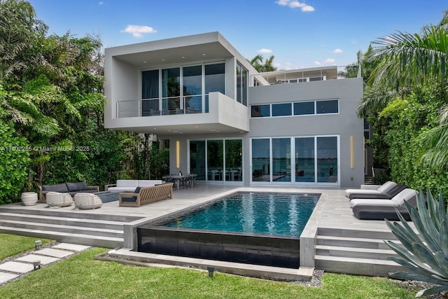 1379 N Venetian Way, Miami, FL 33139 - back of property featuring a balcony, outdoor lounge area, stucco siding, and an outdoor pool