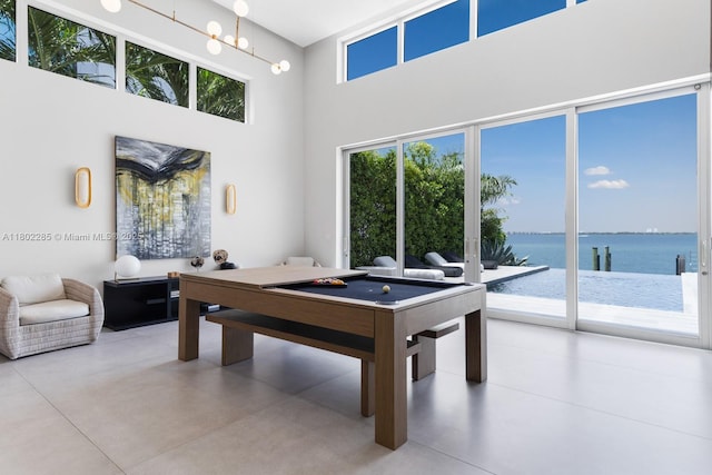 1379 N Venetian Way, Miami, FL 33139 - rec room featuring a high ceiling, concrete floors, plenty of natural light, and a water view