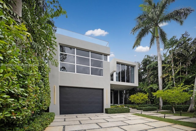 1379 N Venetian Way, Miami, FL 33139 - view of front facade with stucco siding, driveway, and an attached garage