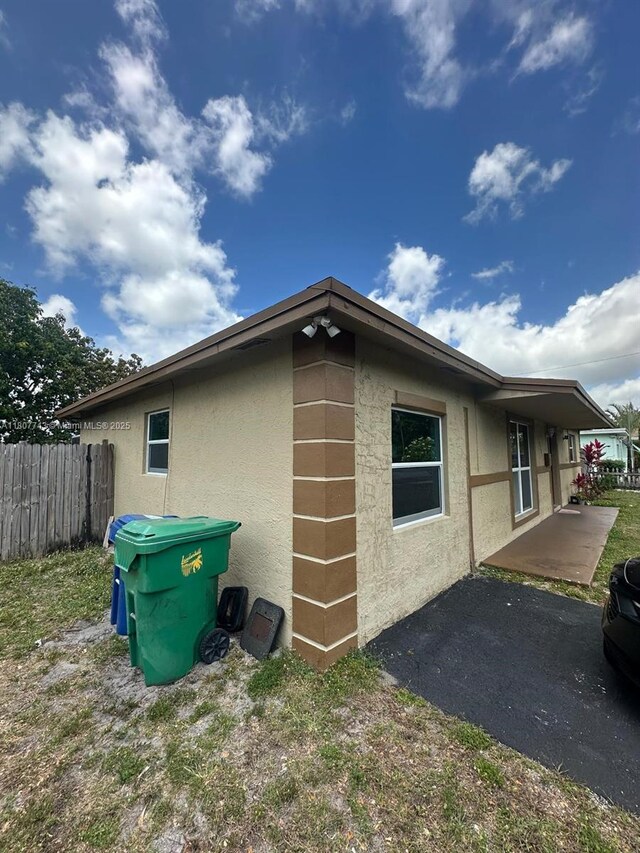 2301 NW 43rd Ter, Lauderhill, FL 33313 - view of home's exterior featuring stucco siding and a patio