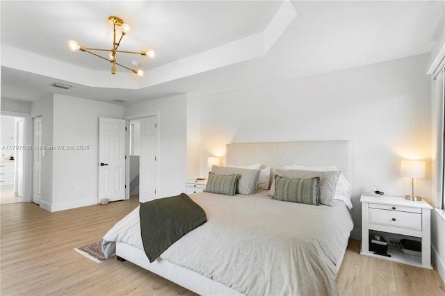 4017 W Gardenia Ave, Weston, FL 33332 - bedroom featuring light wood finished floors, a chandelier, a tray ceiling, and baseboards