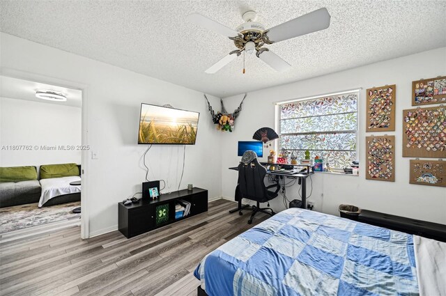 2391 NW 89th Dr Unit 409, Coral Springs, FL 33065 - bedroom featuring wood finished floors, a textured ceiling, and a ceiling fan