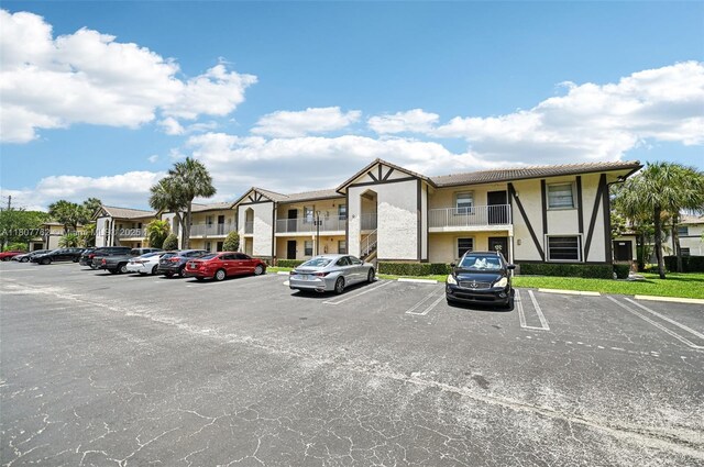 2391 NW 89th Dr Unit 409, Coral Springs, FL 33065 - view of building exterior with uncovered parking and a residential view