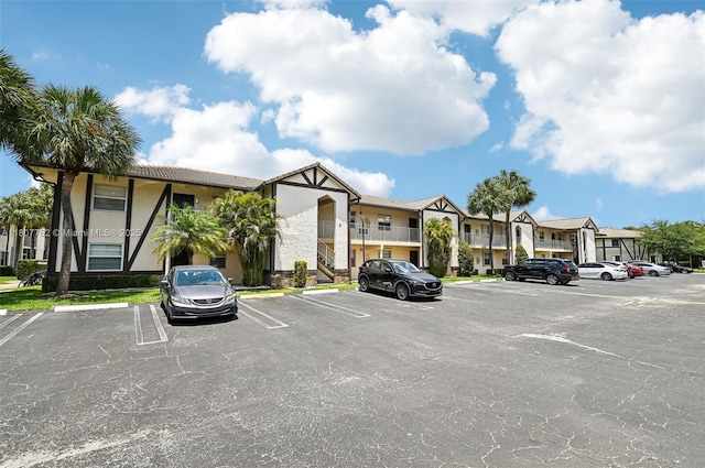 2391 NW 89th Dr Unit 409, Coral Springs, FL 33065 - view of building exterior with uncovered parking and a residential view
