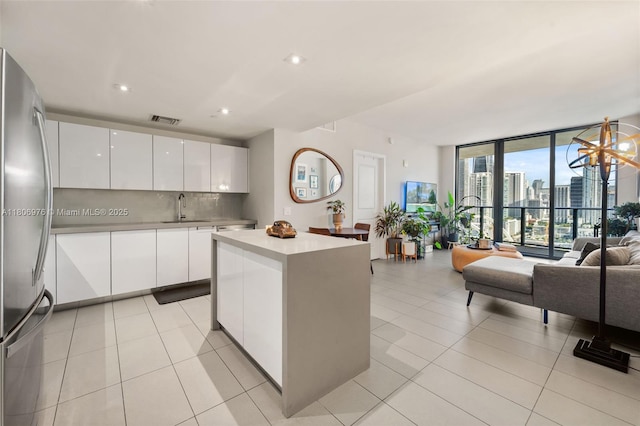 1600 NE 1st Ave Unit 2907, Miami, FL 33132 - kitchen featuring modern cabinets, floor to ceiling windows, freestanding refrigerator, open floor plan, and light countertops