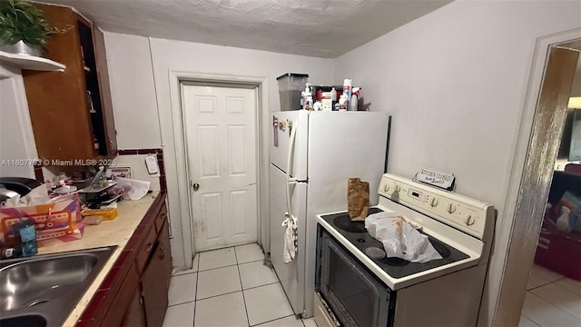1230 NW 113th Ter, Miami, FL 33167 - kitchen featuring white appliances, light tile patterned floors, light countertops, and a sink