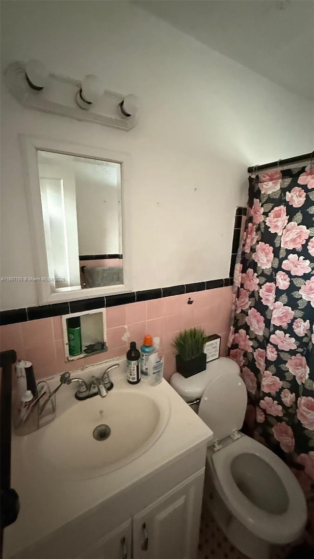 1230 NW 113th Ter, Miami, FL 33167 - bathroom with tile walls, vanity, toilet, wainscoting, and a shower with curtain