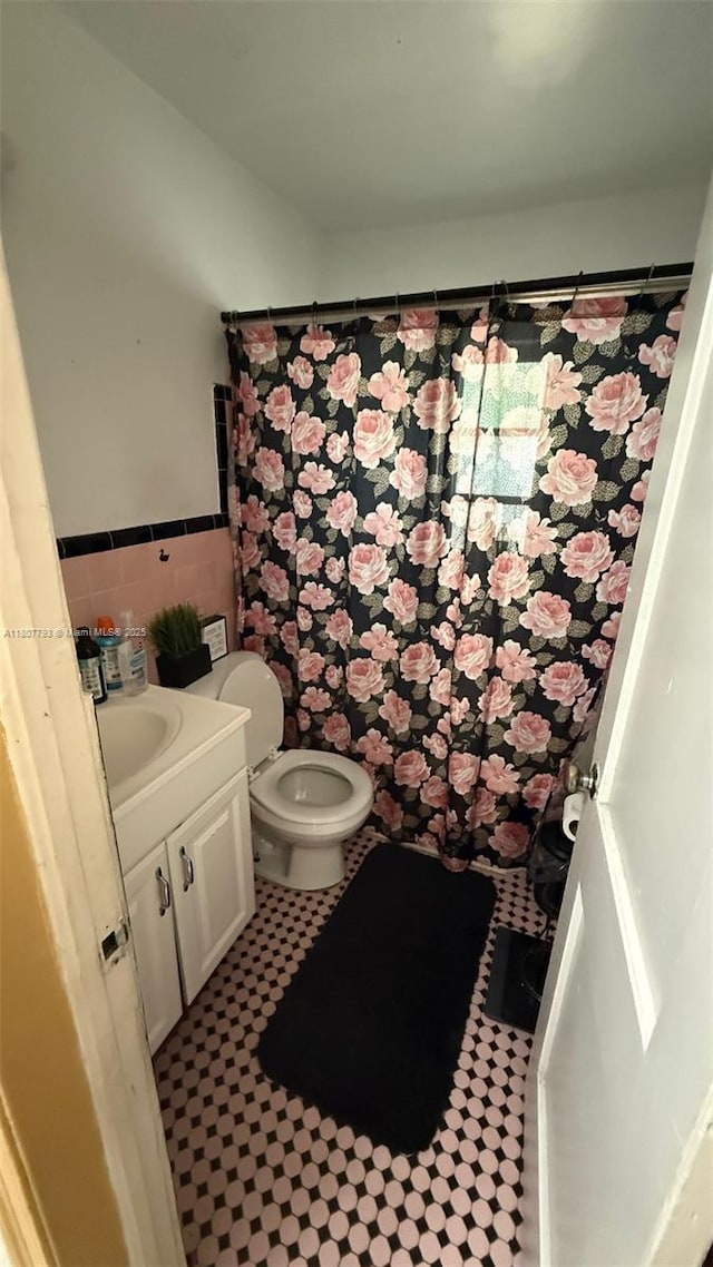 1230 NW 113th Ter, Miami, FL 33167 - full bath with vanity, toilet, tile walls, a wainscoted wall, and curtained shower