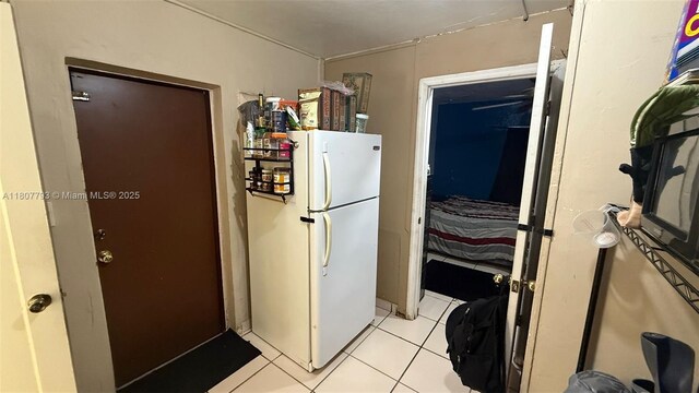 1230 NW 113th Ter, Miami, FL 33167 - kitchen featuring freestanding refrigerator and light tile patterned flooring