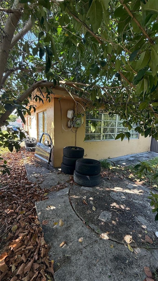 1230 NW 113th Ter, Miami, FL 33167 - view of side of property featuring stucco siding and central air condition unit