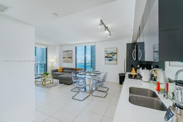 31 SE 6th St Unit 2408, Miami, FL 33131 - kitchen featuring a sink, light tile patterned floors, light countertops, baseboards, and track lighting