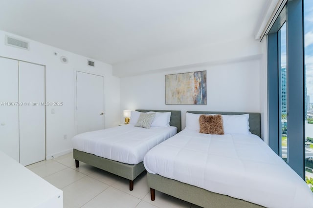 31 SE 6th St Unit 2408, Miami, FL 33131 - bedroom with multiple windows and tile patterned floors