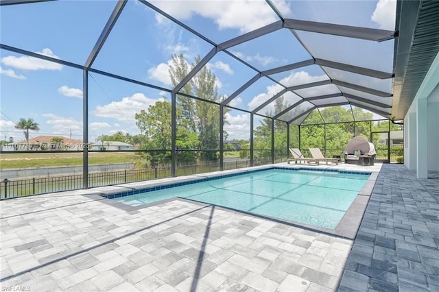 311 SE 14th St, Cape Coral, FL 33990 - view of pool with a patio, area for grilling, a water view, and a lanai