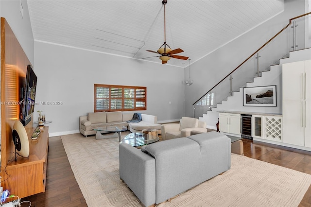 1550 Tyler St, Hollywood, FL 33020 - living room with wine cooler, stairs, wood finished floors, baseboards, and a high ceiling