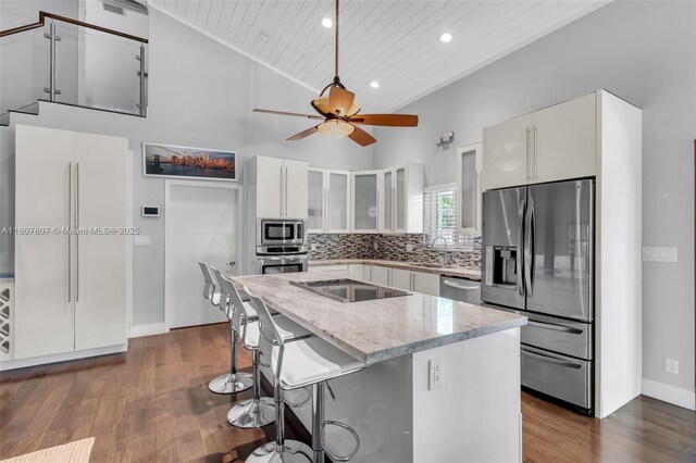 1550 Tyler St, Hollywood, FL 33020 - kitchen with appliances with stainless steel finishes, wooden ceiling, recessed lighting, dark wood-style flooring, and glass insert cabinets