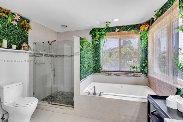 1550 Tyler St, Hollywood, FL 33020 - full bathroom featuring tile patterned flooring, a stall shower, toilet, and a garden tub