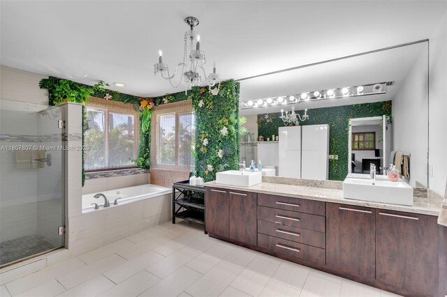 1550 Tyler St, Hollywood, FL 33020 - bathroom featuring double vanity, a garden tub, a shower stall, a chandelier, and tile patterned floors