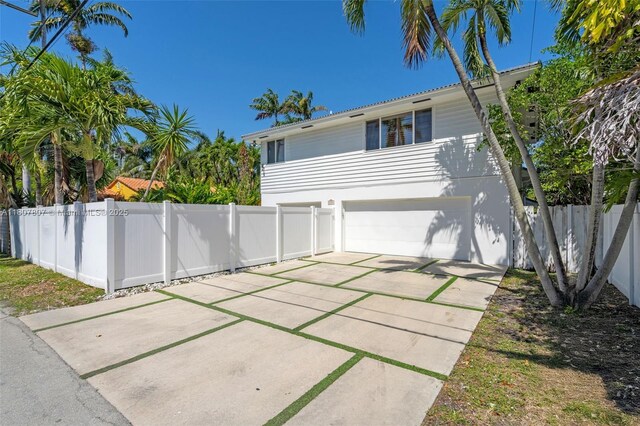 1550 Tyler St, Hollywood, FL 33020 - back of property featuring an attached garage and driveway