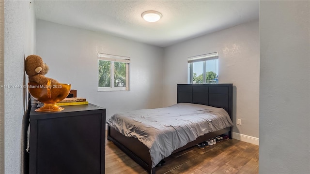 15 W 55th St, Hialeah, FL 33012 - bedroom with wood finished floors and baseboards