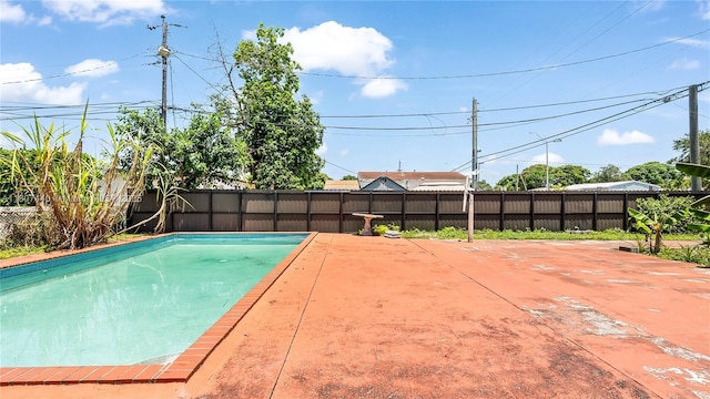 15 W 55th St, Hialeah, FL 33012 - view of pool featuring a fenced backyard and a patio area