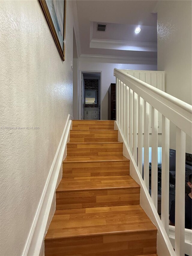 15029 SW 8th Ter, Miami, FL 33194 - stairs featuring ornamental molding, wood finished floors, a textured wall, and recessed lighting