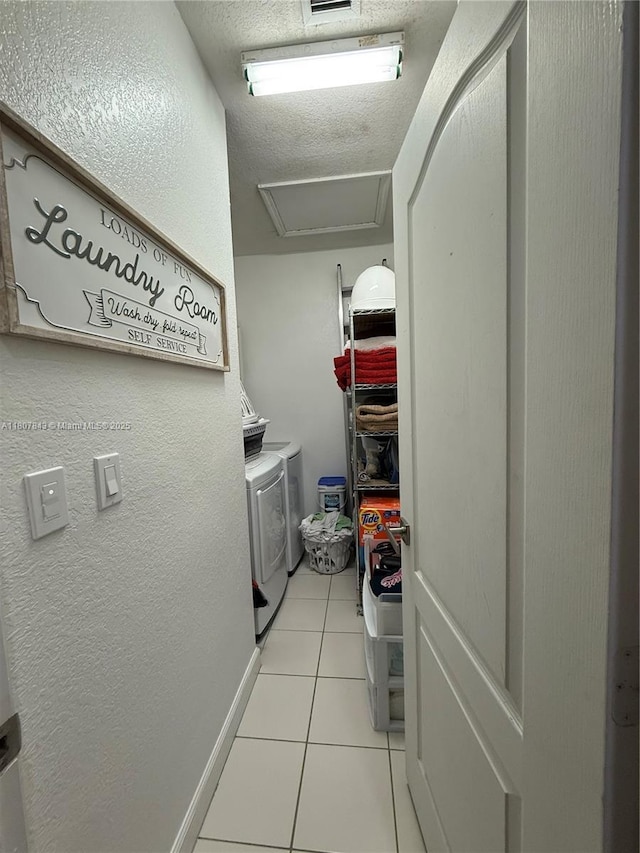 15029 SW 8th Ter, Miami, FL 33194 - laundry area featuring washing machine and clothes dryer, light tile patterned floors, attic access, and a textured ceiling