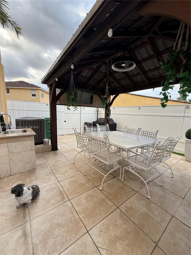 15029 SW 8th Ter, Miami, FL 33194 - view of patio featuring outdoor dining space, a gazebo, central air condition unit, and a sink