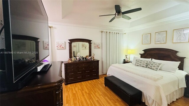 15029 SW 8th Ter, Miami, FL 33194 - bedroom with a tray ceiling, light wood finished floors, a ceiling fan, and ornamental molding
