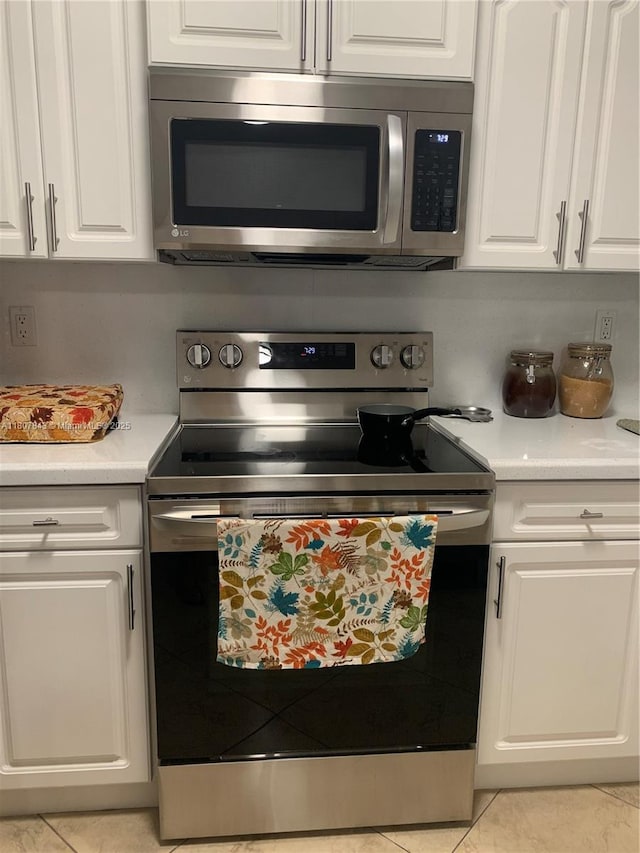 15029 SW 8th Ter, Miami, FL 33194 - kitchen with appliances with stainless steel finishes, white cabinetry, light countertops, and light tile patterned flooring