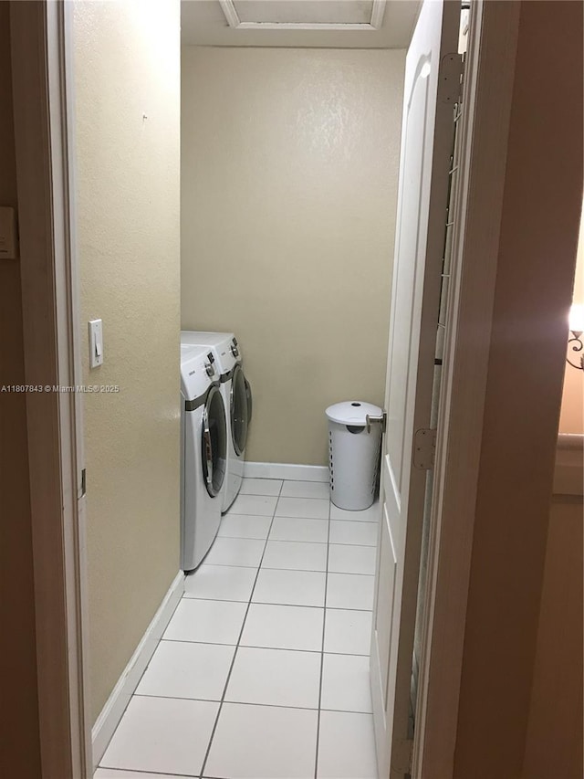 15029 SW 8th Ter, Miami, FL 33194 - laundry room with washing machine and clothes dryer, light tile patterned flooring, and baseboards