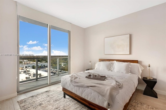 3900 Biscayne Blvd Unit N-905, Miami, FL 33137 - bedroom featuring access to exterior, light tile patterned floors, and baseboards