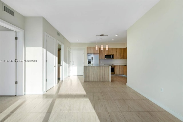 3900 Biscayne Blvd Unit N-905, Miami, FL 33137 - kitchen featuring stainless steel appliances, light countertops, brown cabinets, a center island, and modern cabinets