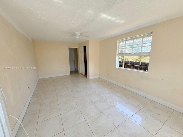 18201 NW 20th Ave, Miami Gardens, FL 33056 - unfurnished room with a textured ceiling, light tile patterned floors, ceiling fan, and baseboards