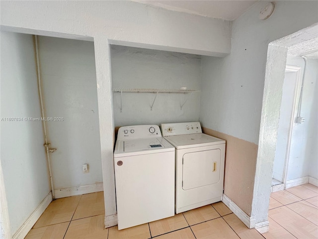 18201 NW 20th Ave, Miami Gardens, FL 33056 - laundry room with washing machine and clothes dryer, light tile patterned floors, and baseboards
