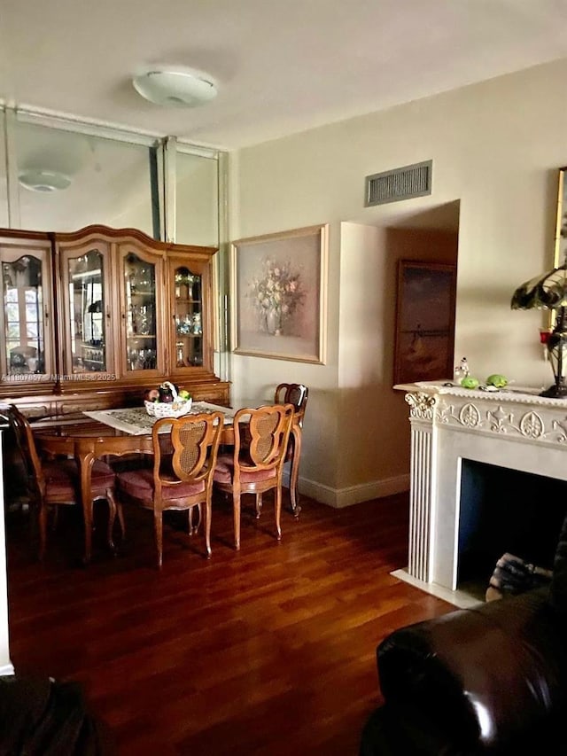 7707 Ashmont Cir Unit 214, Tamarac, FL 33321 - dining space with wood finished floors, baseboards, and a fireplace with flush hearth