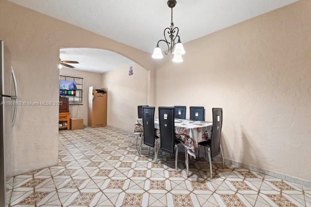 2655 NW 14th Ave, Miami, FL 33142 - dining space featuring arched walkways, a chandelier, and a textured wall