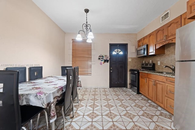 2655 NW 14th Ave, Miami, FL 33142 - dining area featuring a chandelier
