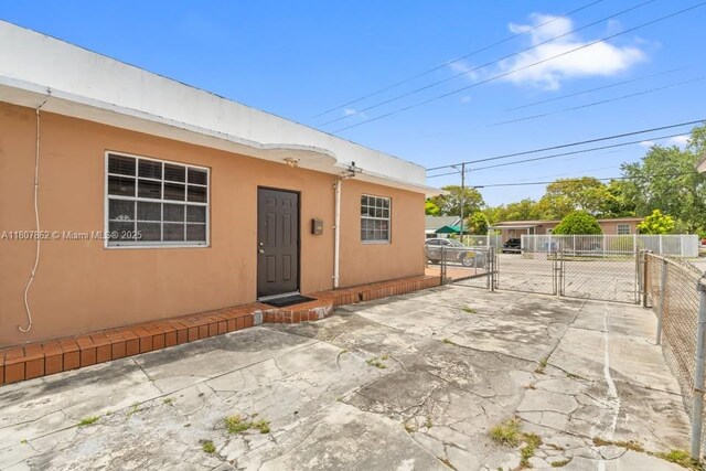 2655 NW 14th Ave, Miami, FL 33142 - property entrance with a gate and stucco siding