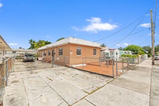 2655 NW 14th Ave, Miami, FL 33142 - view of front of home featuring a gate, a fenced front yard, and stucco siding