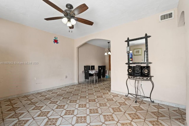 2655 NW 14th Ave, Miami, FL 33142 - empty room with arched walkways, ceiling fan, baseboards, and a chandelier
