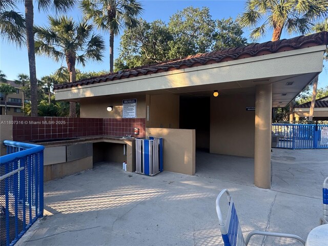 15569 N Miami Lakeway N Unit 204, Miami Lakes, FL 33014 - exterior space with stucco siding and a tiled roof