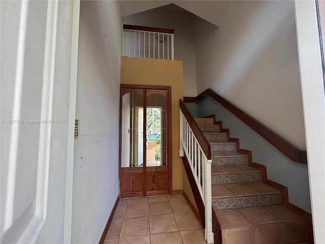 15569 N Miami Lakeway N Unit 204, Miami Lakes, FL 33014 - entrance foyer featuring a high ceiling, stairs, baseboards, and light tile patterned floors