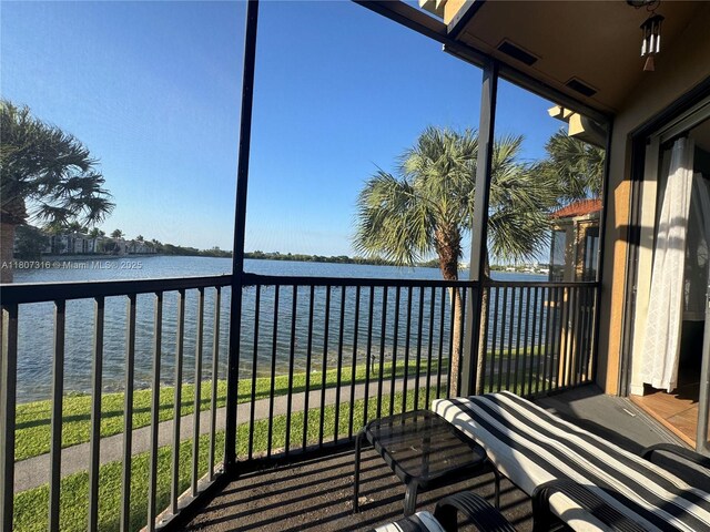 15569 N Miami Lakeway N Unit 204, Miami Lakes, FL 33014 - unfurnished sunroom with a water view and plenty of natural light