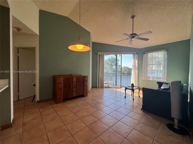 15569 N Miami Lakeway N Unit 204, Miami Lakes, FL 33014 - living room with vaulted ceiling, ceiling fan, a textured ceiling, light tile patterned flooring, and a water view